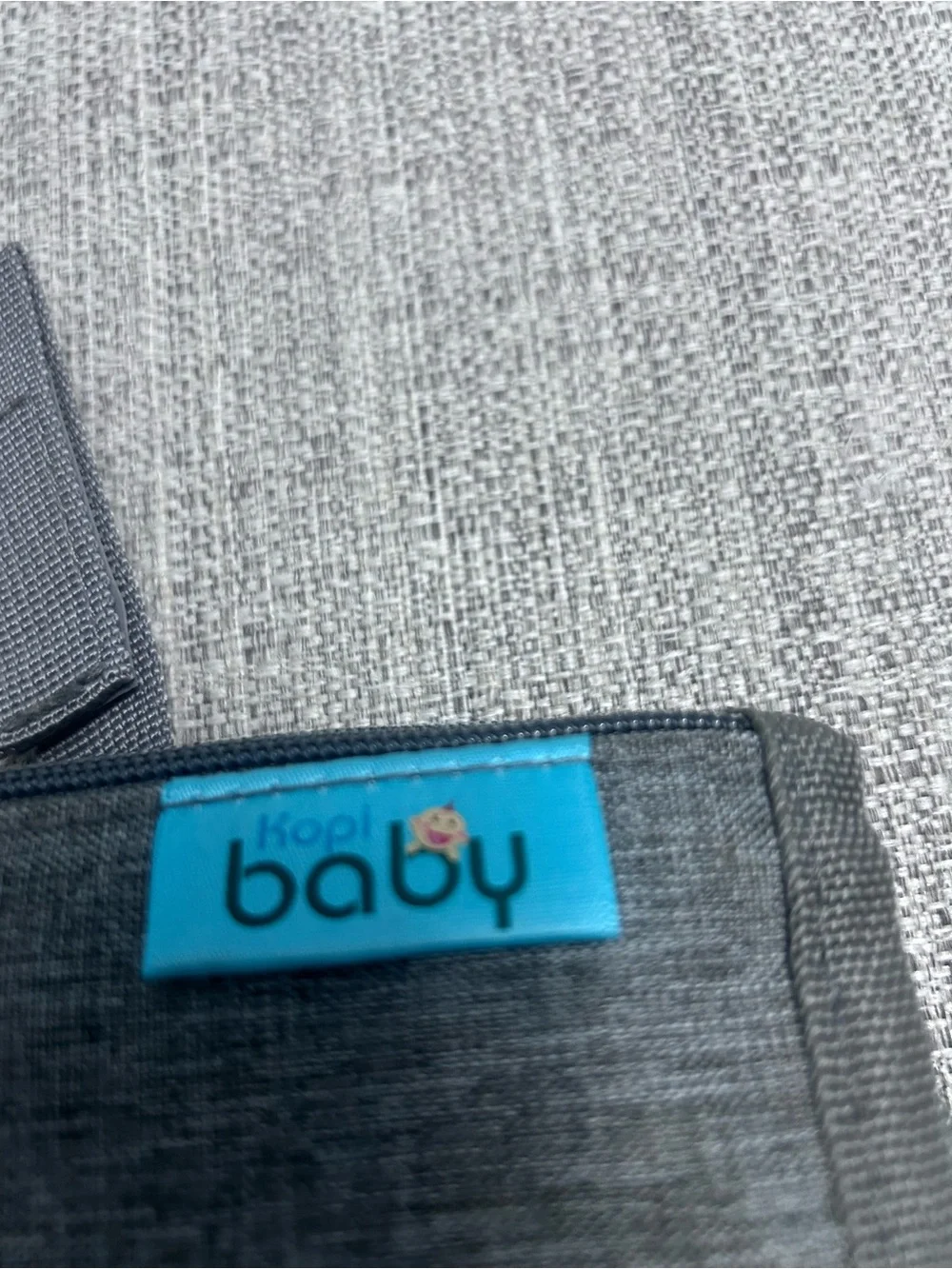 Grey Foldable Portable Changing Pad for Baby with Secure Buckle.